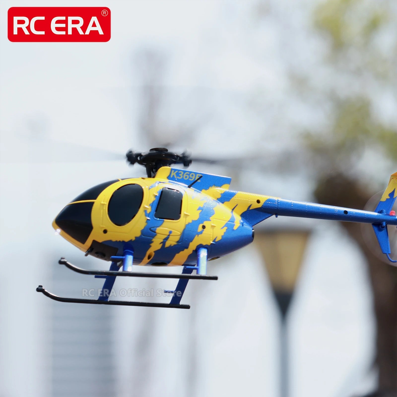 Toy helicopter with blue and yellow design on a blurred background, featuring the RC ERA brand.