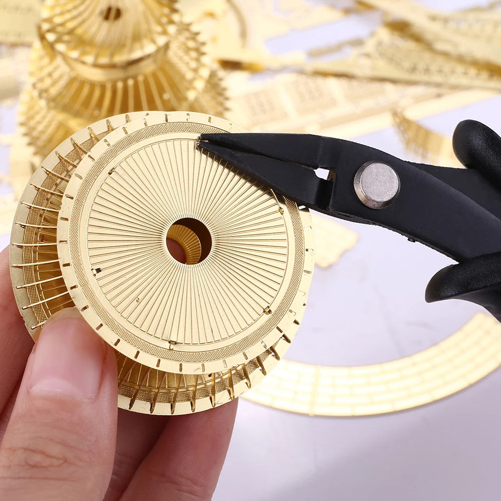 Gold circular object being cut with black scissors on a white background