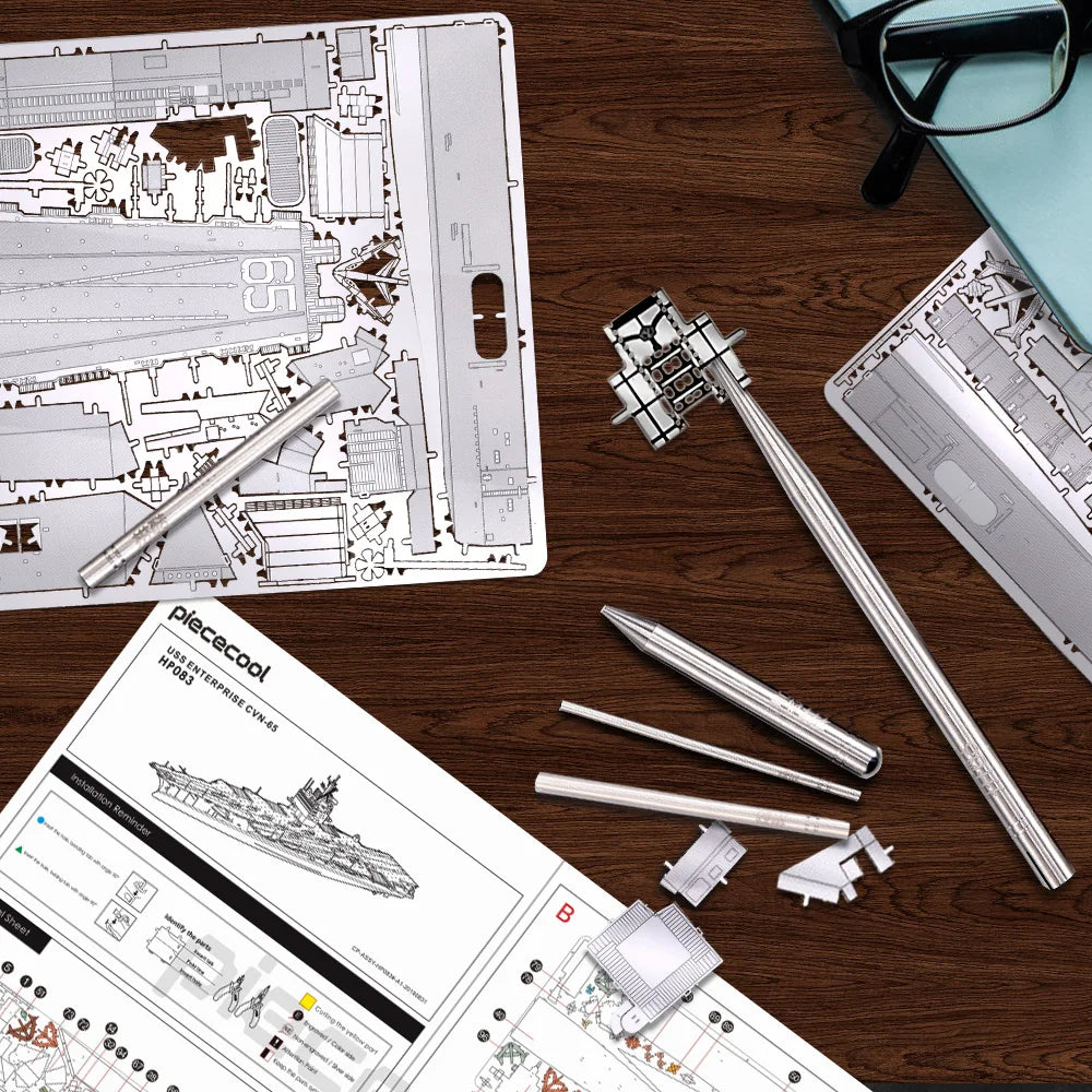 Model building kit components and instructions on a wooden table