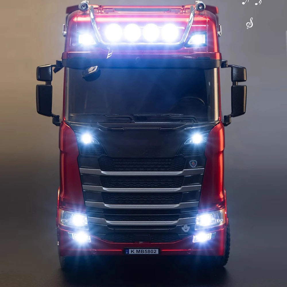 Model truck with illuminated lights on a dark background