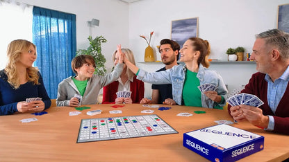 Family playing Sequence board game together in a living room.