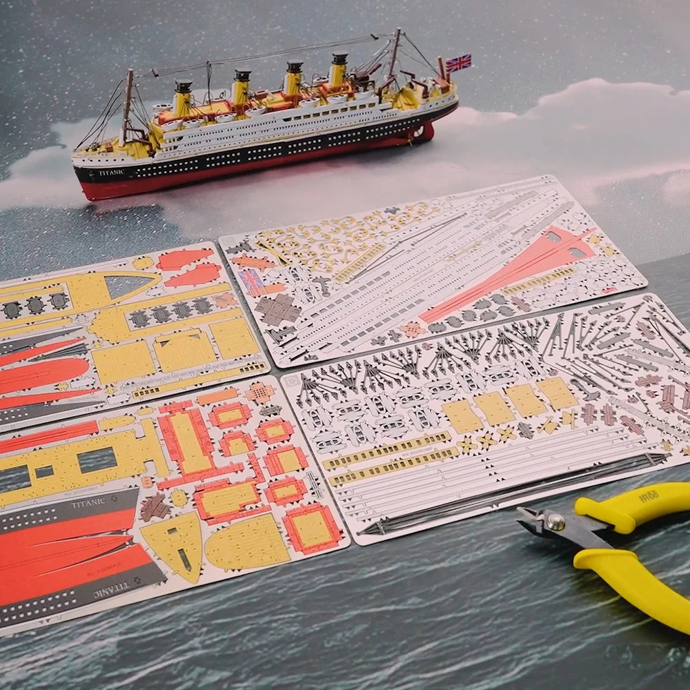 Model ship kit with detailed parts and a pair of scissors on a table with a ship model in the background.