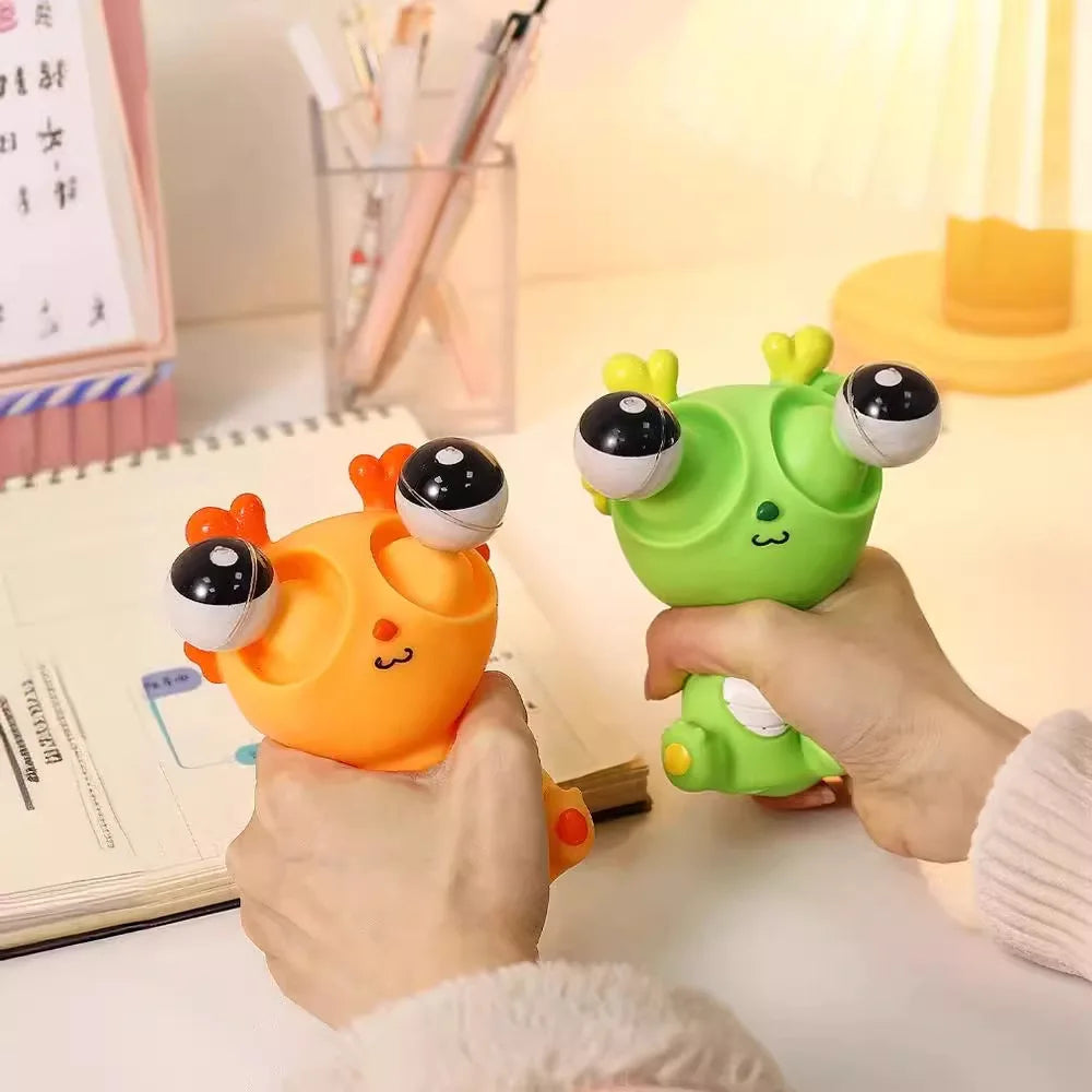 Two colorful toy guns, one orange and one green, held by hands on a desk.