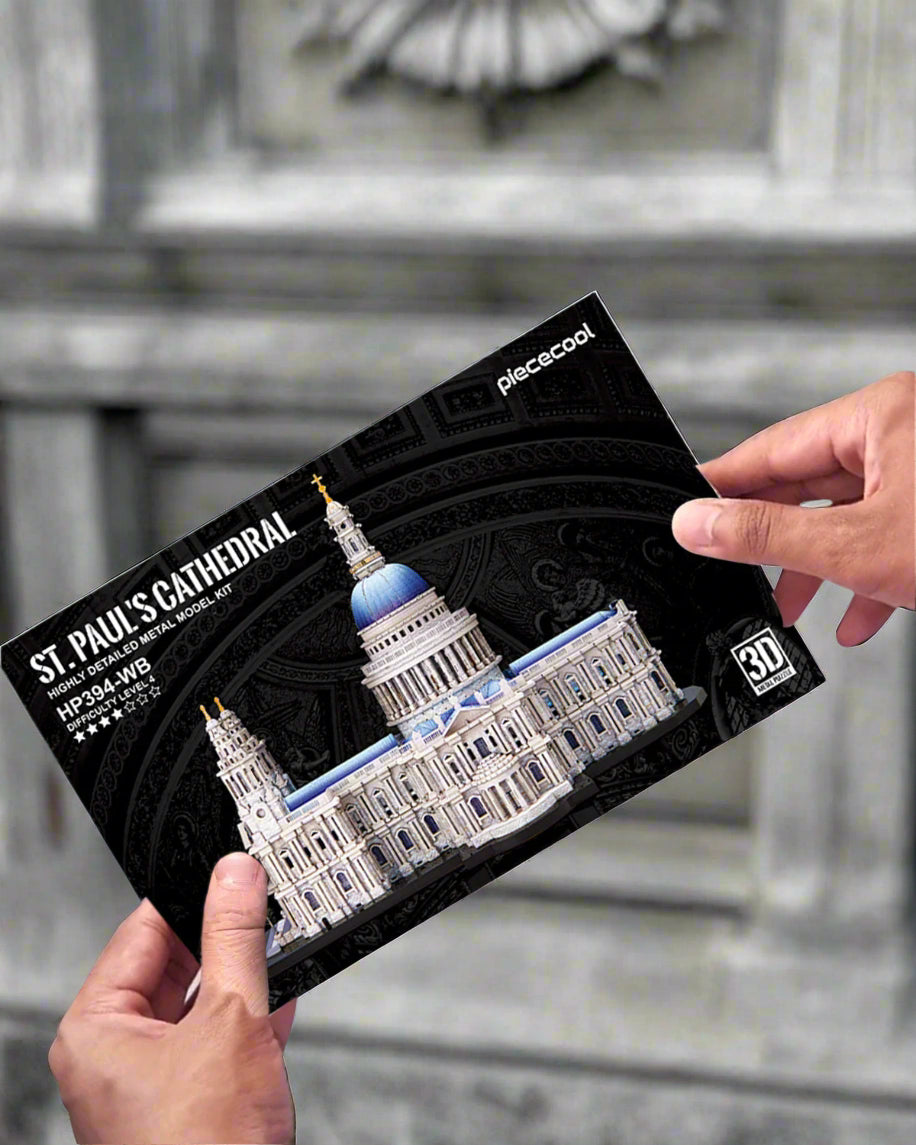 St. Paul's Cathedral model kit packaging held by hands with a blurred cathedral background