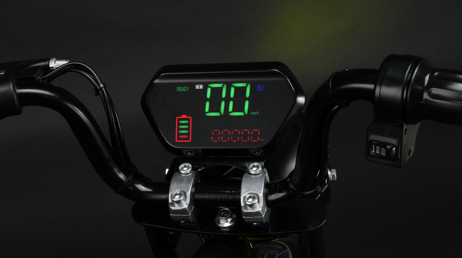 Digital display on a motorcycle handlebar with green and red text against a dark background