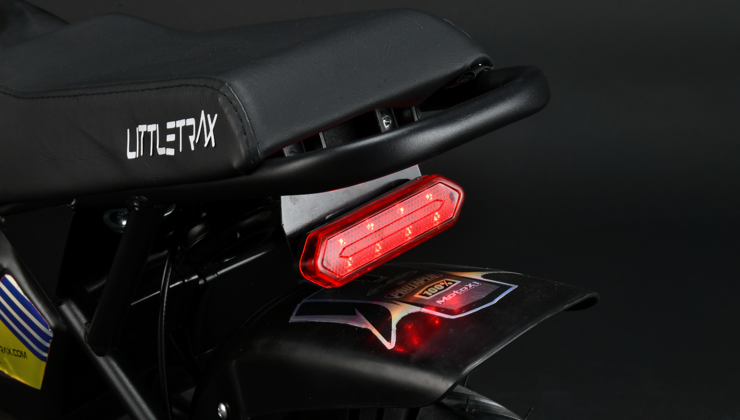 Littletrax 350W Kids Electric Bike Close-up of a LittleTrax bike seat with a red taillight on a dark background