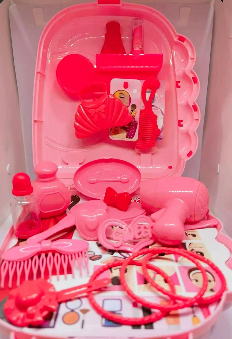 Pink toy hair salon set with various tools in a clear plastic case.