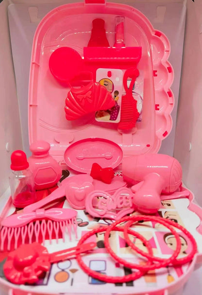 Pink toy hair salon set with various tools in a clear plastic case.