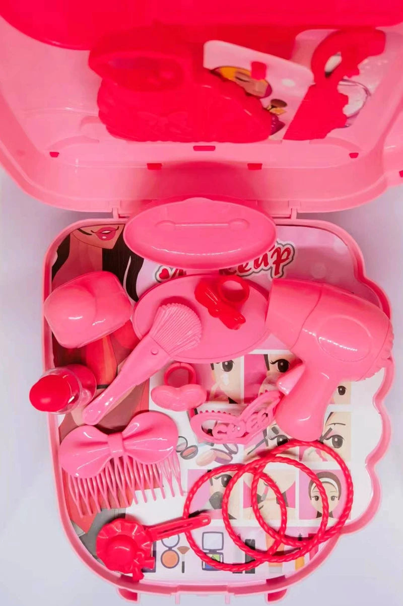 Pink toy hair salon set with various tools on a white background