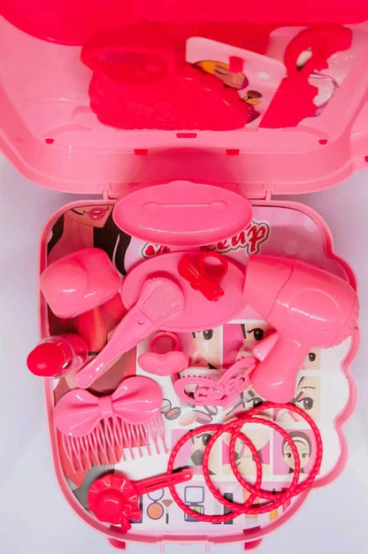 Pink toy hair salon set with various tools on a white background