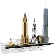 A building block set representation of the New York City skyline, featuring models of the Empire State Building, Statue of Liberty, and other notable structures.