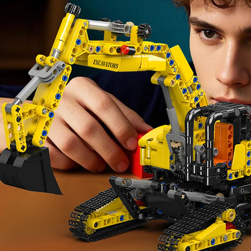 Person playing with a toy excavator set on a table