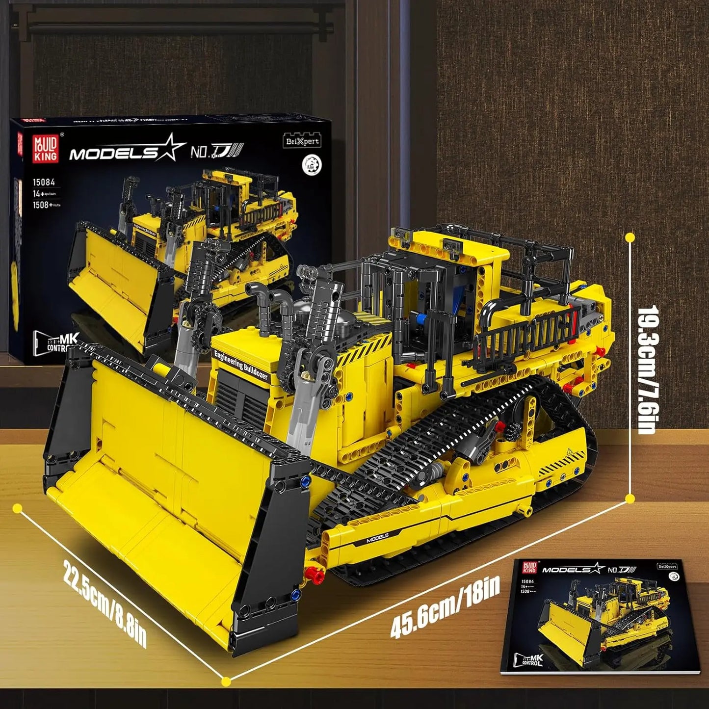 Toy bulldozer set with packaging and measurements on a wooden surface
