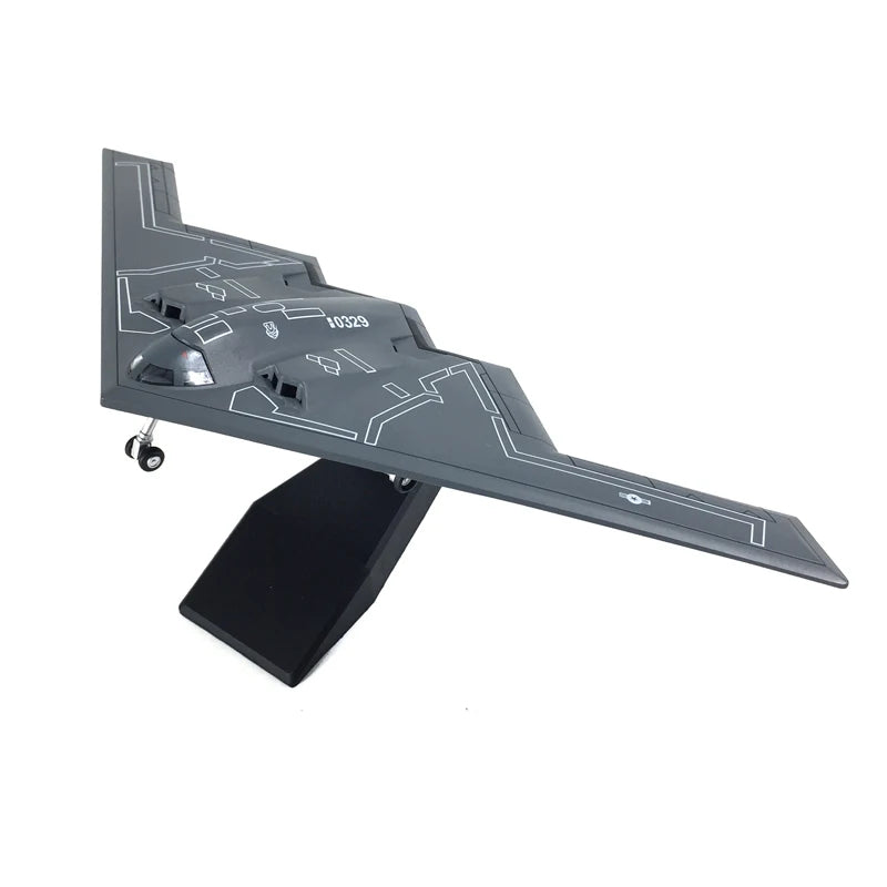 Model of a stealth aircraft on a stand with a white background