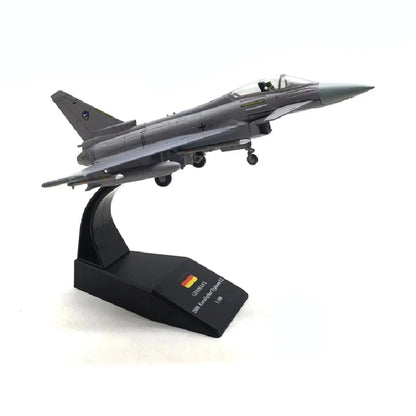 Model of a fighter jet on a black stand with a white background