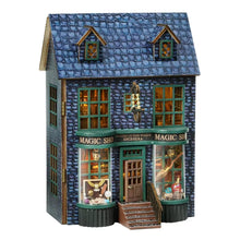 Model of a magical shop with blue roof and green windows on a white background