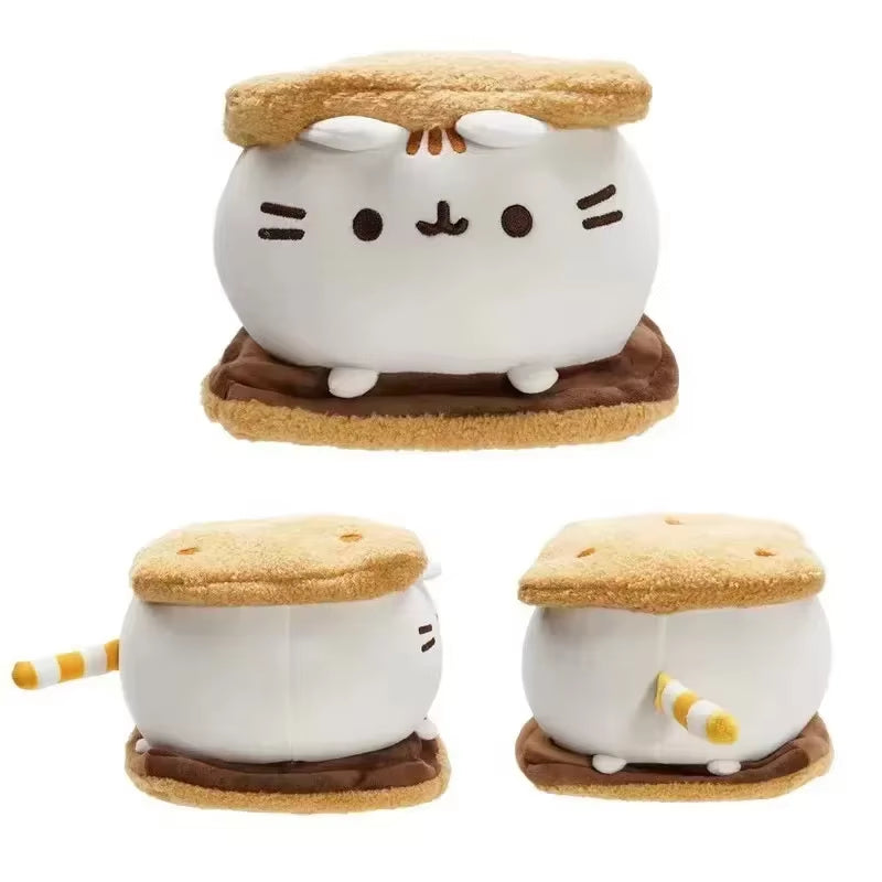 Plush toy resembling a cat inside a s'more with marshmallow and graham cracker on a white background