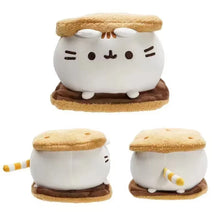Plush toy resembling a cat inside a s'more with marshmallow and graham cracker on a white background