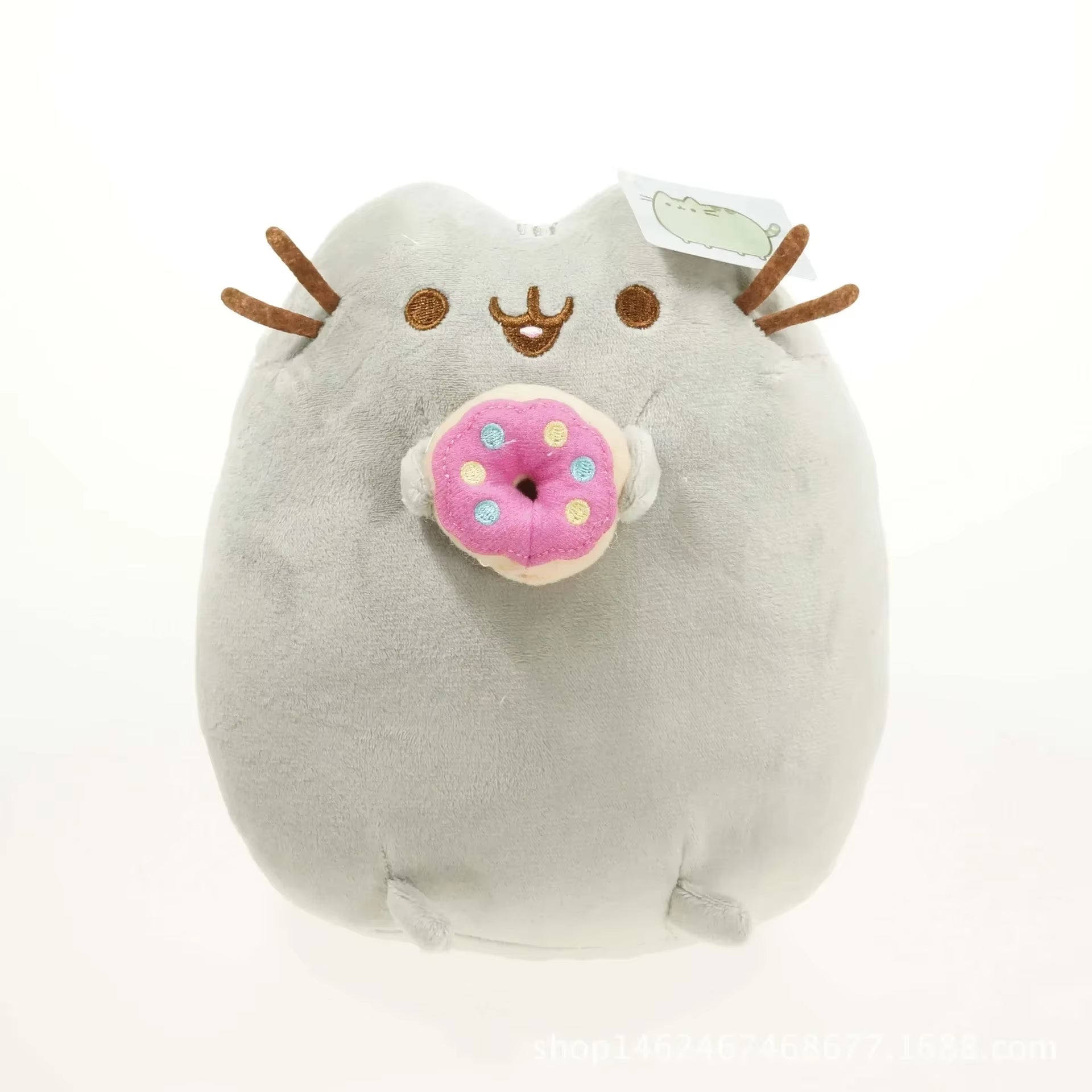 Plush toy resembling a cat with antlers and a donut on a white background