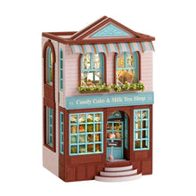 Model of a candy cake and milk tea shop with a colorful awning and detailed facade.