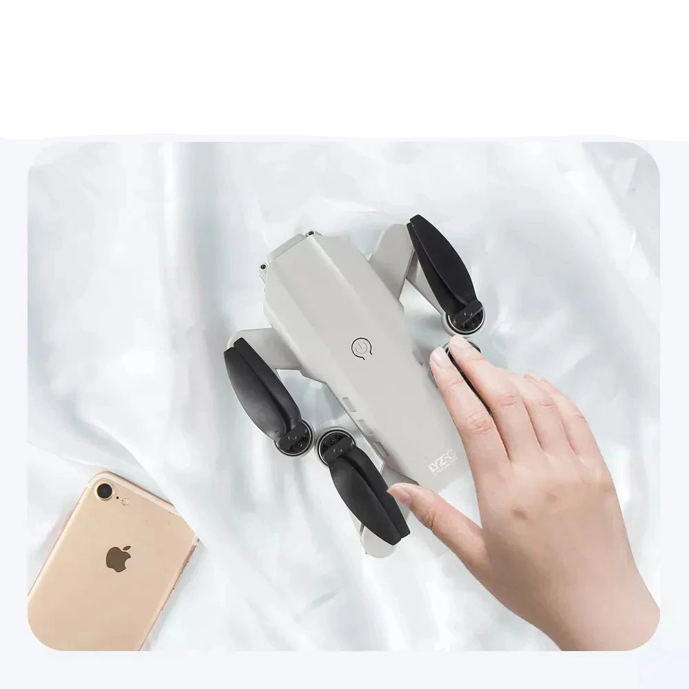 Hand holding a white electronic device with black components on a white background