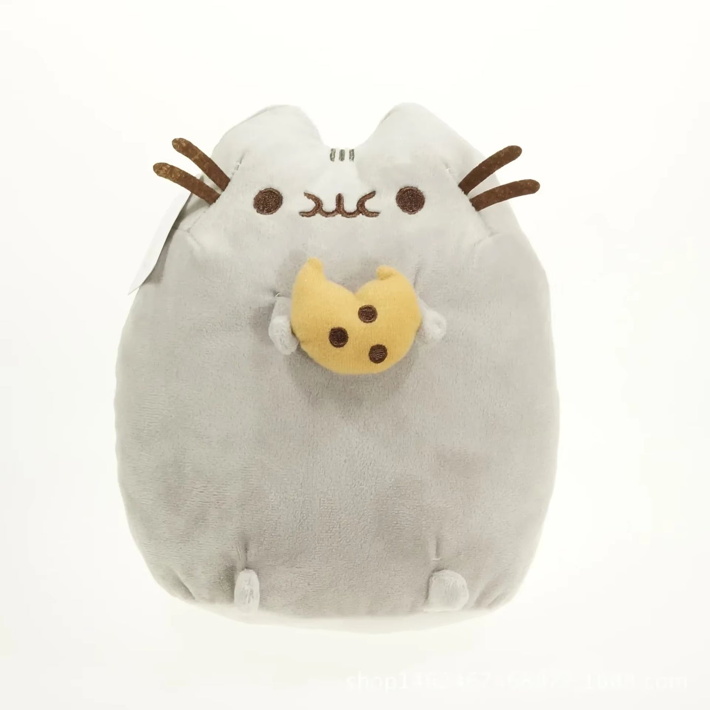 Plush toy resembling a cat with a cookie on a white background