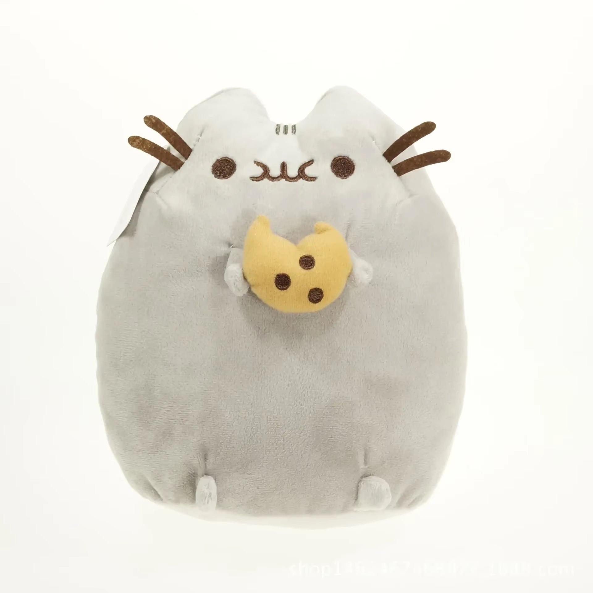 Plush toy resembling a cat with a cookie on a white background
