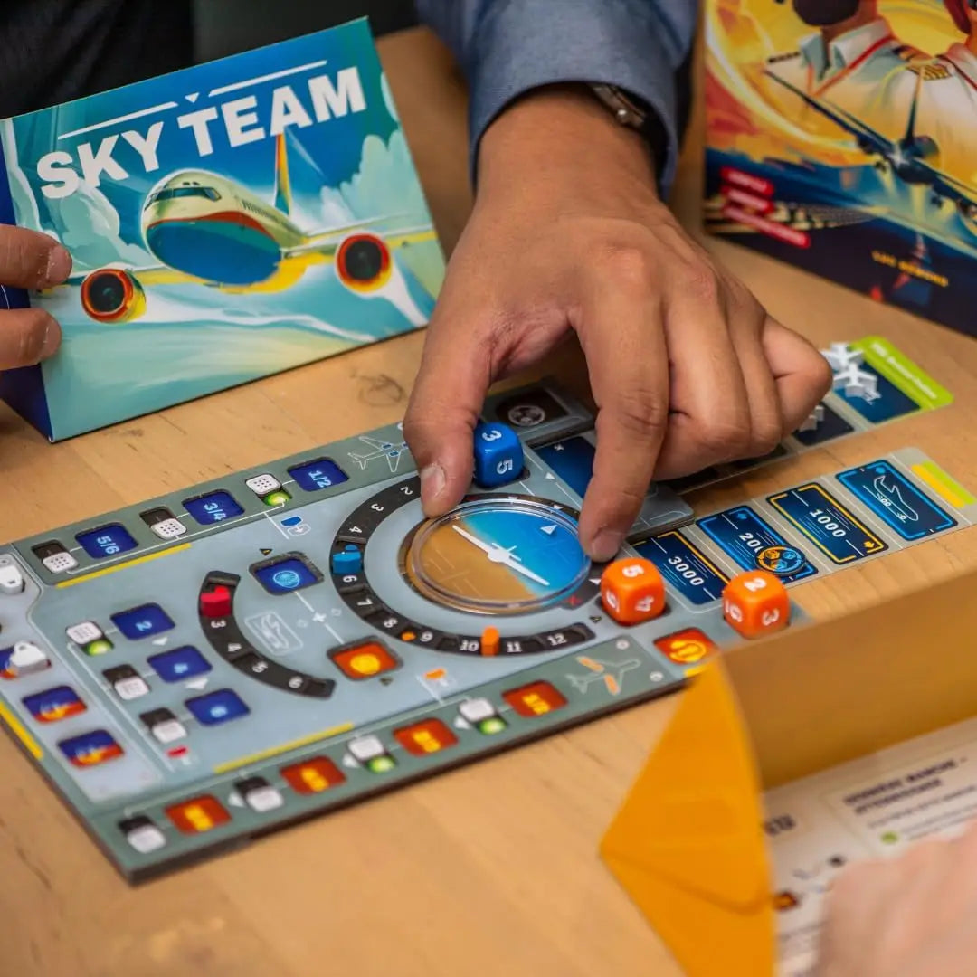 Person playing a board game with 'Sky Team' theme on a wooden table