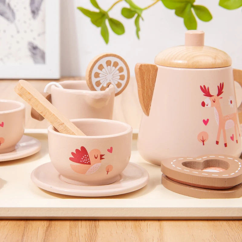 Wooden tea set with deer design on a wooden surface