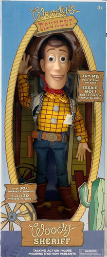 Toy figure of Woody from Toy Story in packaging with branding and text.