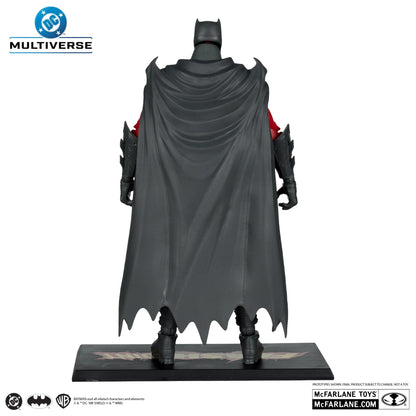 Batman figure with dark gray cape and red accents on a white background, featuring Multiverse and McFarlane Toys branding.