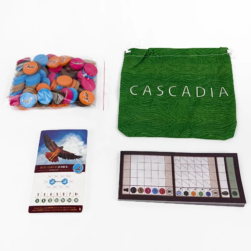 Collection of items including colorful buttons, a green bag with 'Cascadia' branding, a box with an eagle design, and a grid chart on a white background.