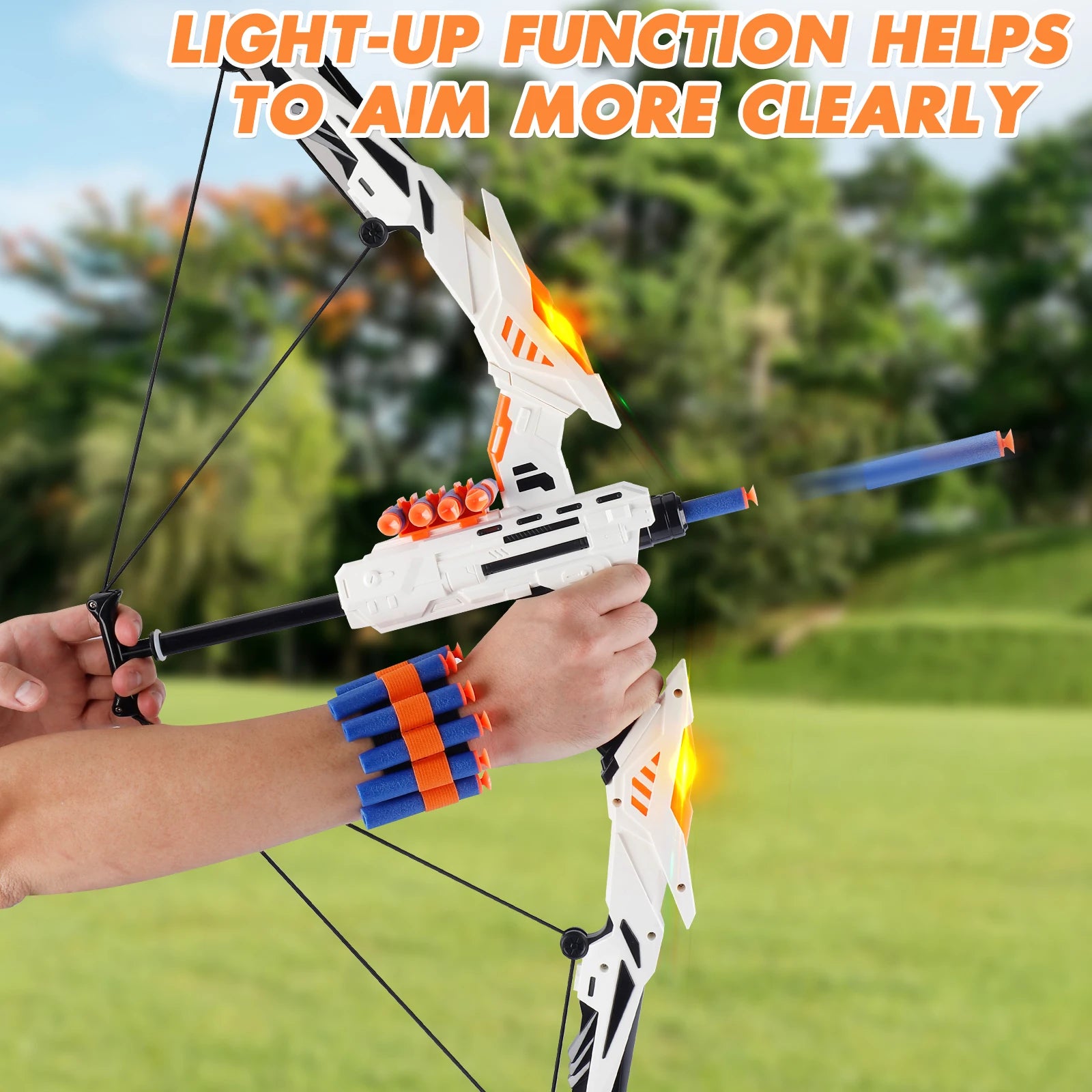 Toy bow and arrow set with light-up function held by a person outdoors.