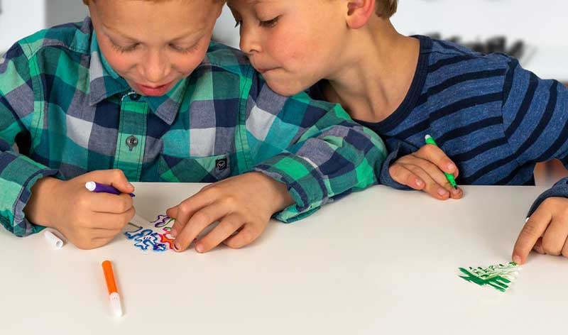 National Geographic Crystal Garden - Grow incredible crystal covered trees Two children sitting at a table coloring with markers.