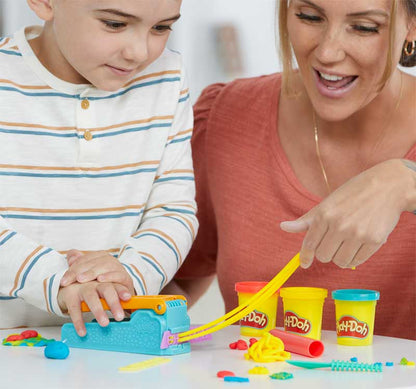 Woman and child playing with Play-Doh toys at a table.