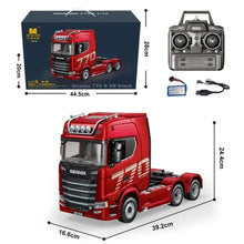 Red model truck with remote control, battery, and cable on a white background