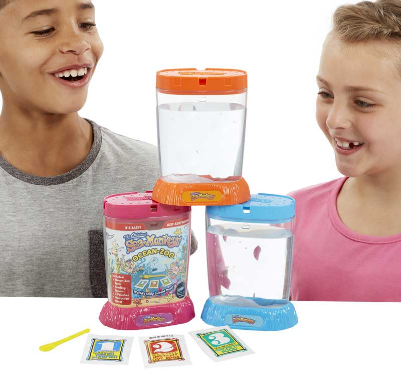 The Original Sea Monkeys - Ocean Zoo Grow Your Own Pets Science Kit 6+ years Two children playing with a toy aquarium set on a white background