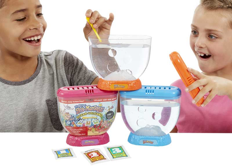 Sea Monkeys Volcano Zoo - The Original Sea Monkeys with Larger Tank & Volcano Children playing with a toy set featuring colorful containers and tools on a white background